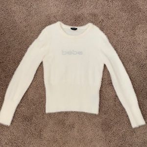 Bebe sweater, medium size, cream fuzzy material.